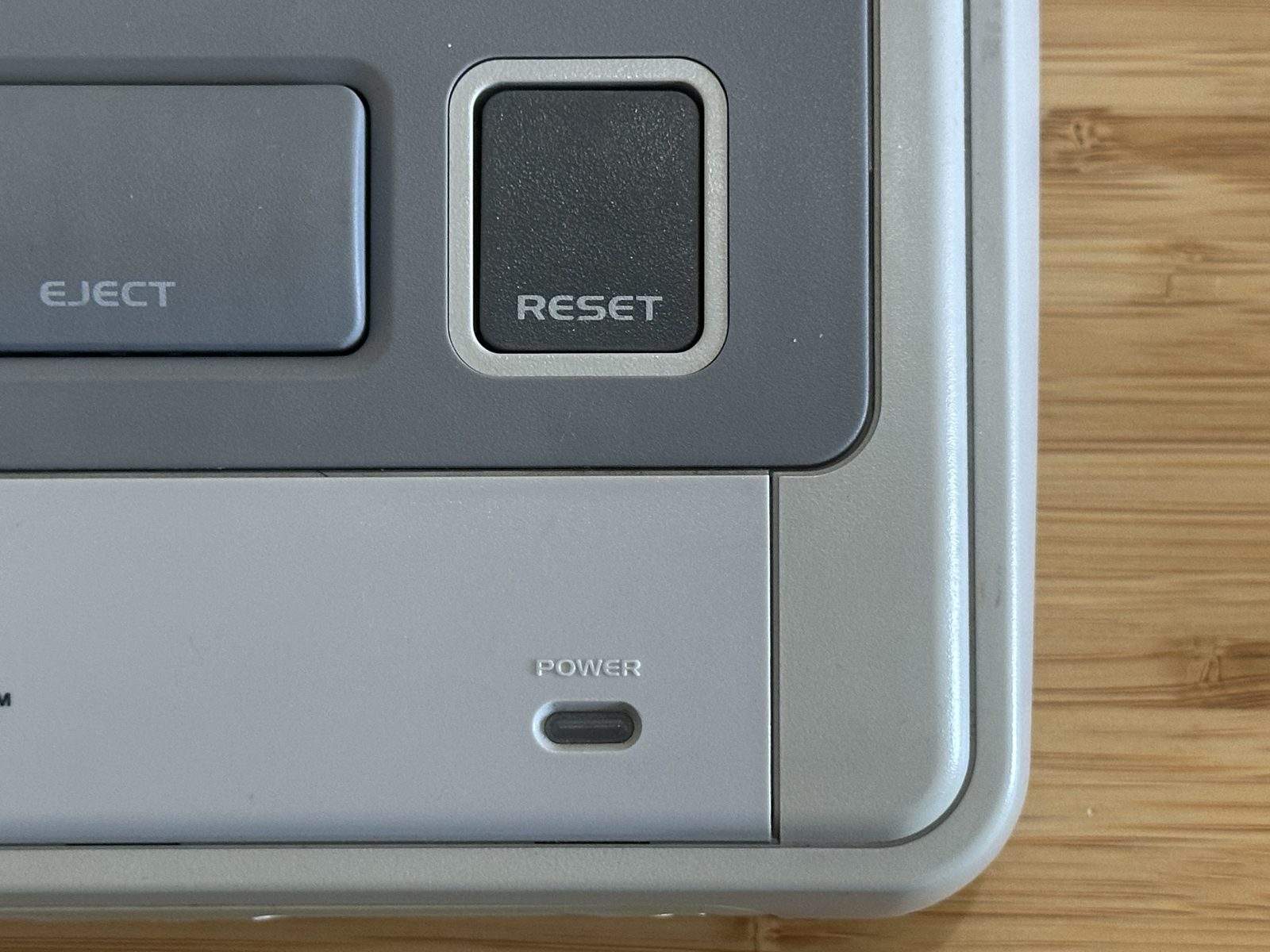 Close-up of the Reset button on a PAL Super Nintendo console