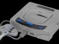 A grey first-generation Japanese Sega Saturn console with controller