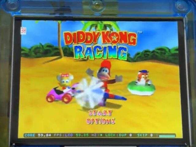 Taki Udon's transparent-blue FPGBA SP prototype screen running Diddy Kong Racing (N64) as a power demonstration.