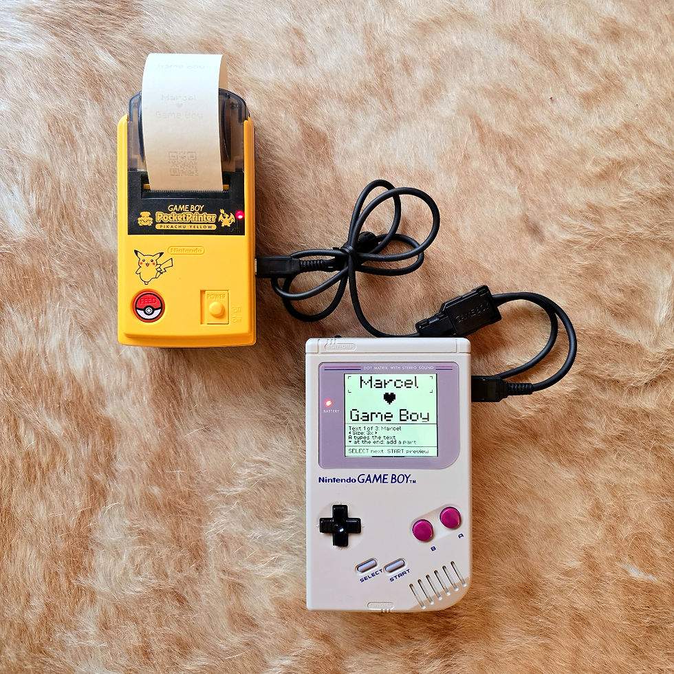 A Game Boy Printer printing a custom LABEL BOY label reading 'Marcel LOVES Game Boy'