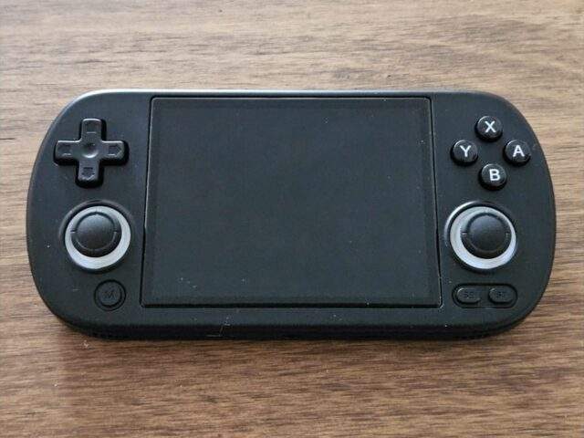 A black budget retro handheld with twin analog sticks and ABXY buttons