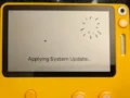 A yellow Playdate handheld displaying the Questy Chess game on its screen