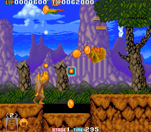 Gameplay screenshot from the 1989 Toki arcade game showing Toki the ape in a jungle level